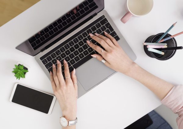 flat-lay-woman-working-laptop